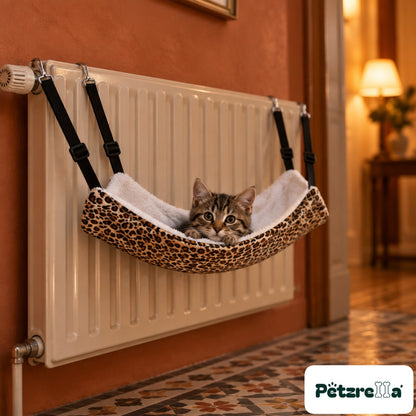 Petzrella Pet Cage Hammock on a radiator with a tabby kitten peeking out