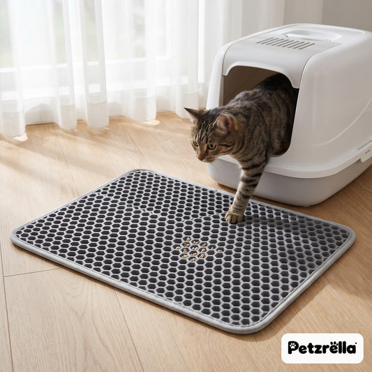 Petzrella grey honeycomb cat litter mat in front of a litter box, tabby cat stepping out in a bright home