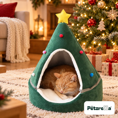 Petzrella Christmas Tree Cat Cave in green with yellow star, ginger cat sleeping inside next to a Christmas tree