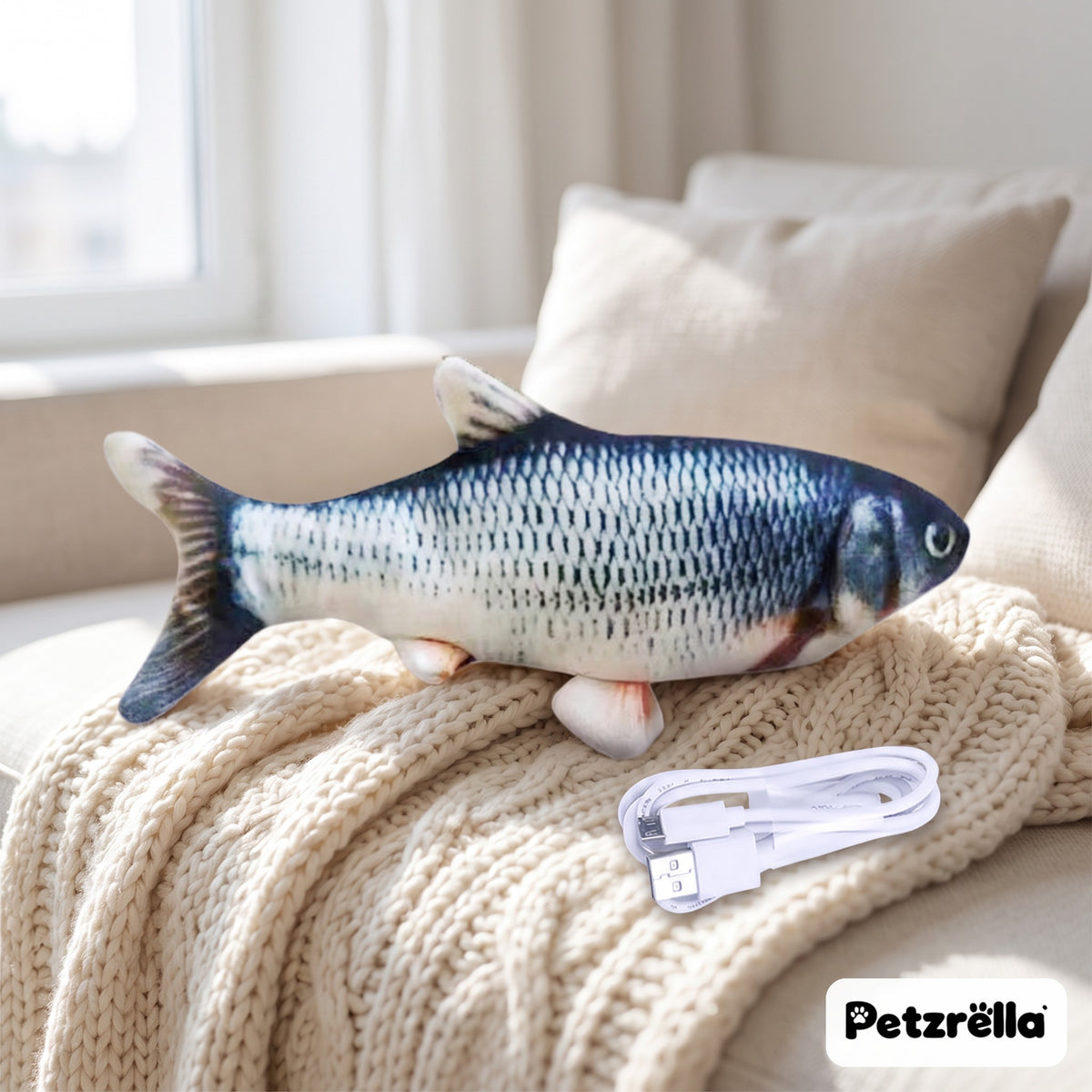 Petzrella blue carp flopping fish cat toy with USB charging cable on a knitted blanket