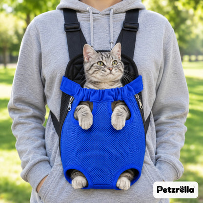 Tabby cat in the blue Petzrella front pet carrier, legs out, worn on the chest in a park