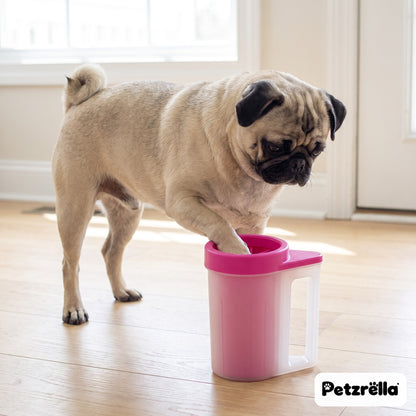 Petzrella pink portable paw cleaner cup with a pug cleaning its paw in a bright entryway